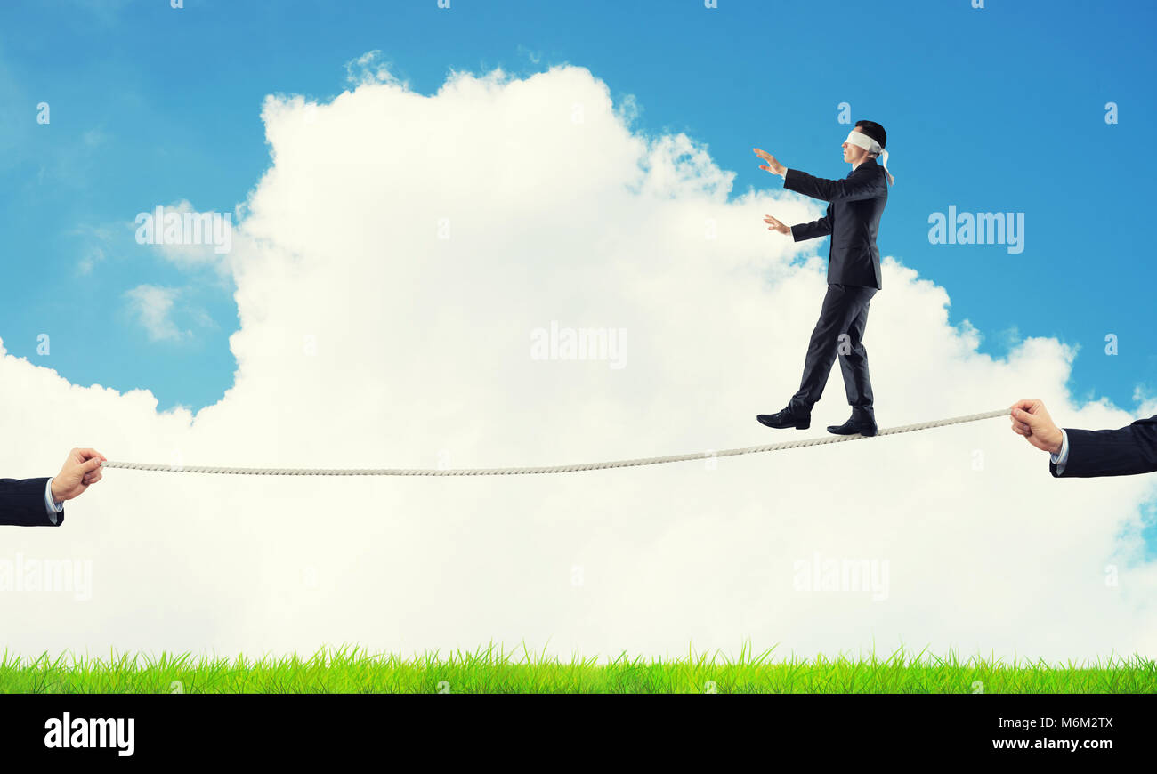 Business concept of risk support and assistance with man balancing on ...