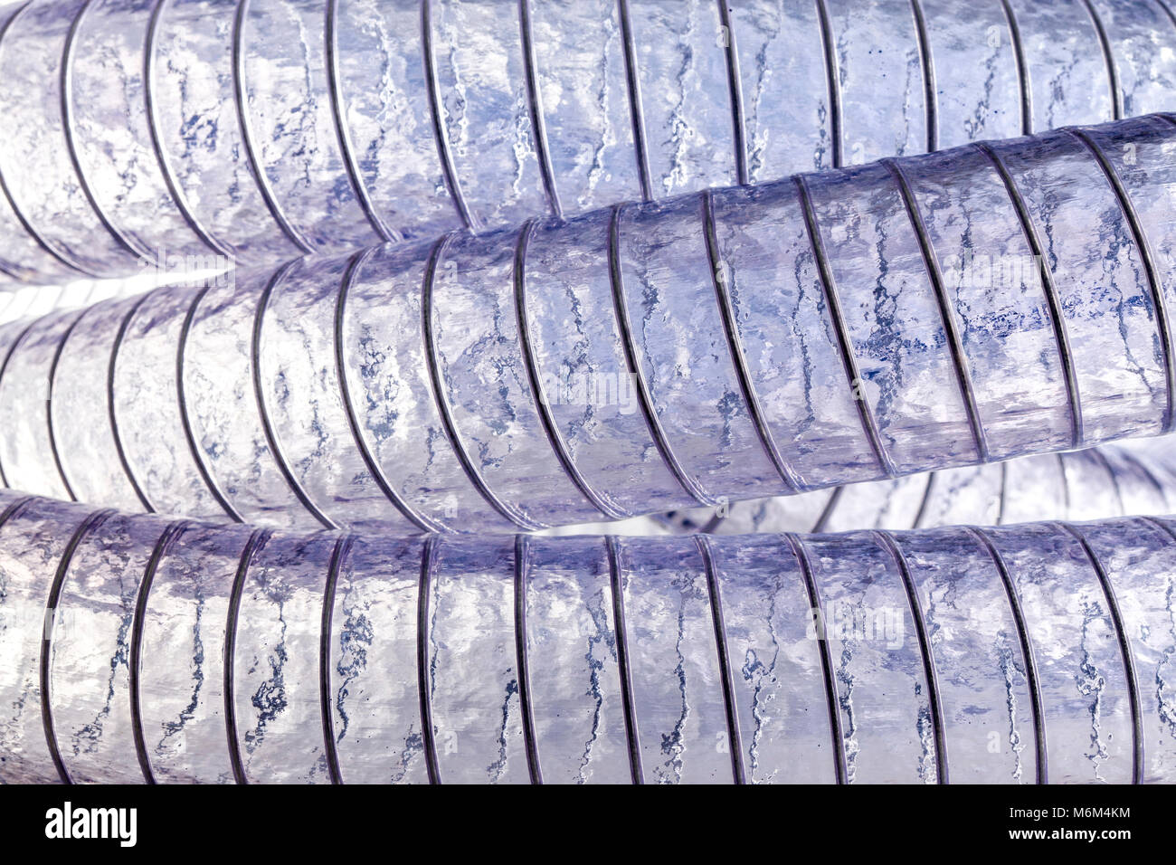 detail of transparent coiled pvc pipe background Stock Photo