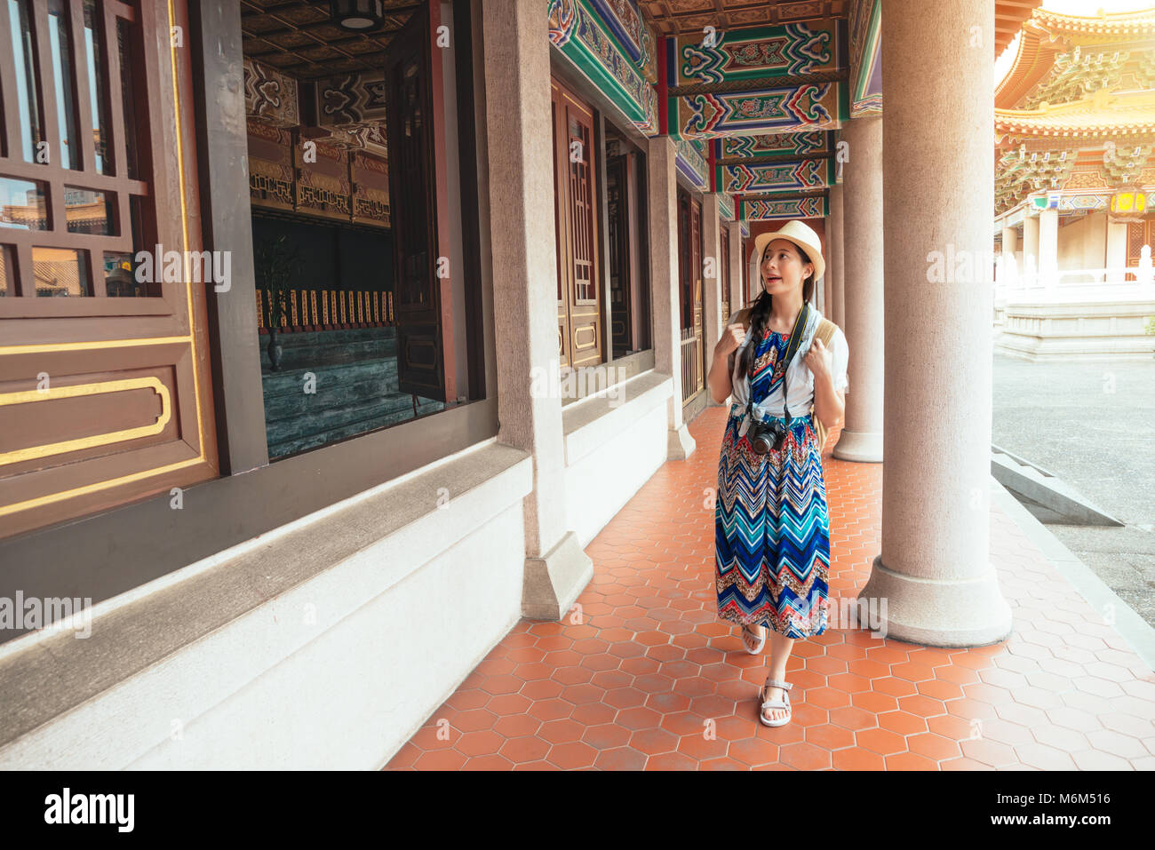 Traditional Backpackers Young charming backpacker woman walking through old traditional long ...