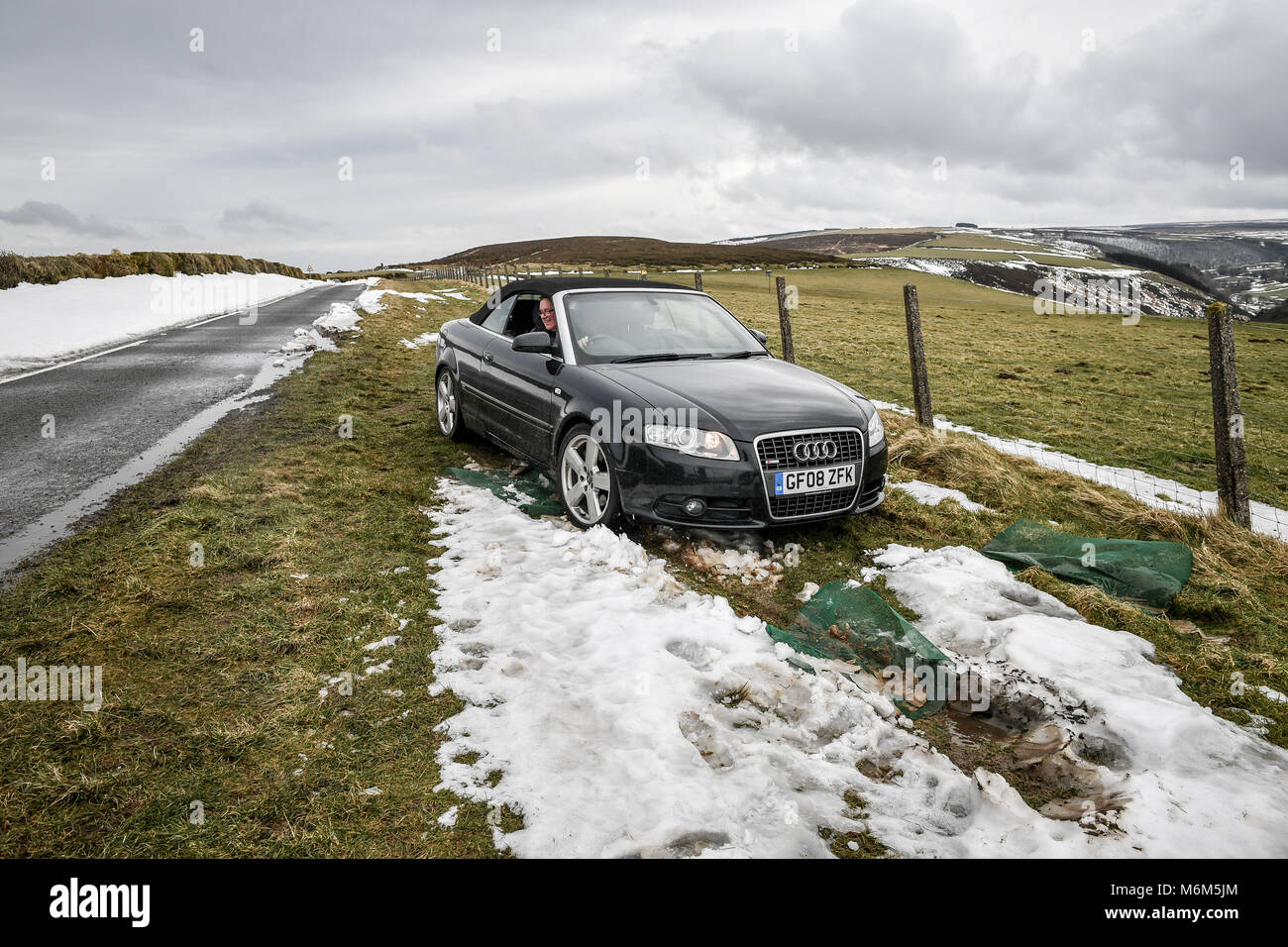 A man recovers his car he abandoned on the A39 Exmoor near