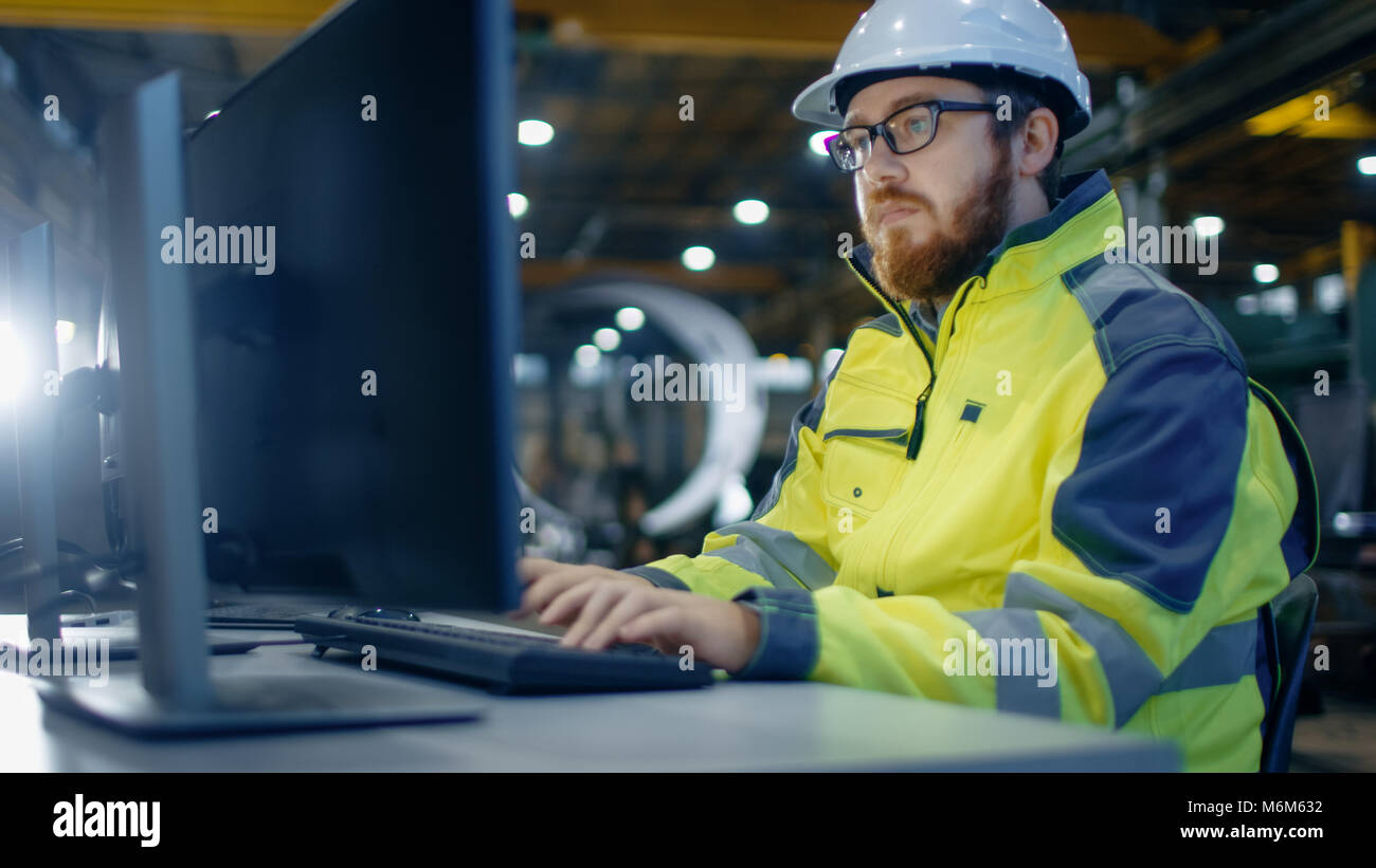 industrial engineer works at workspace on a personal computer he industrial engineering works
