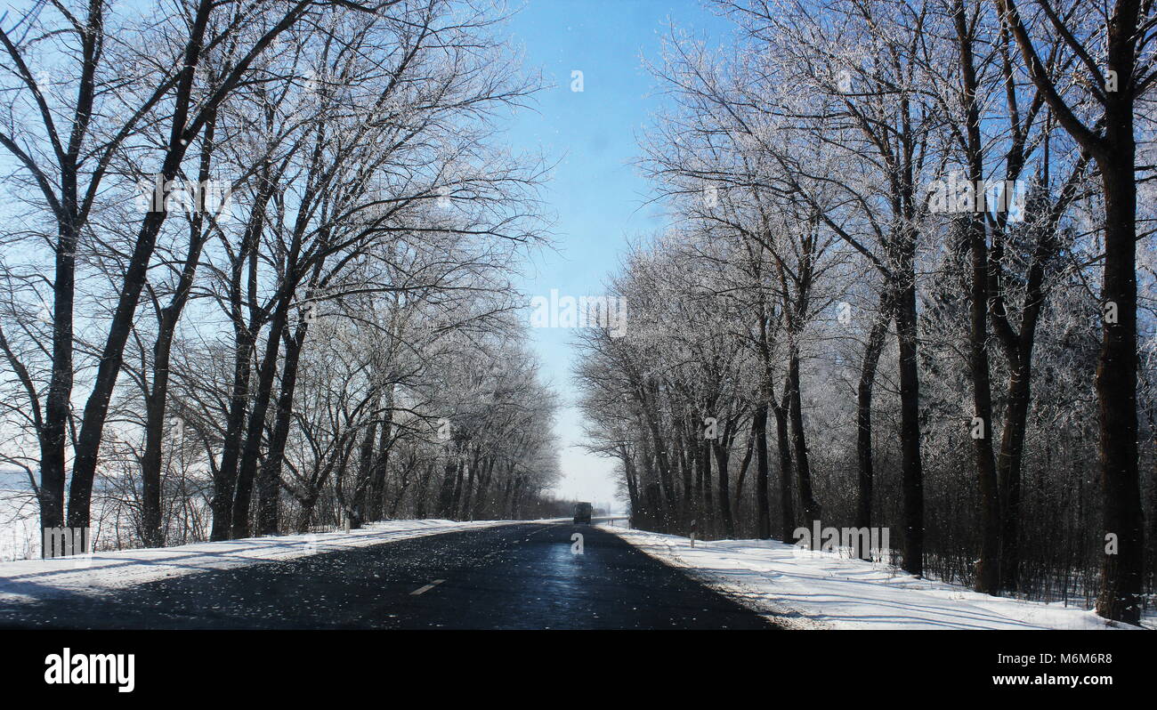 beautiful winter landscape with asphalt road,forest and blue sky Stock ...
