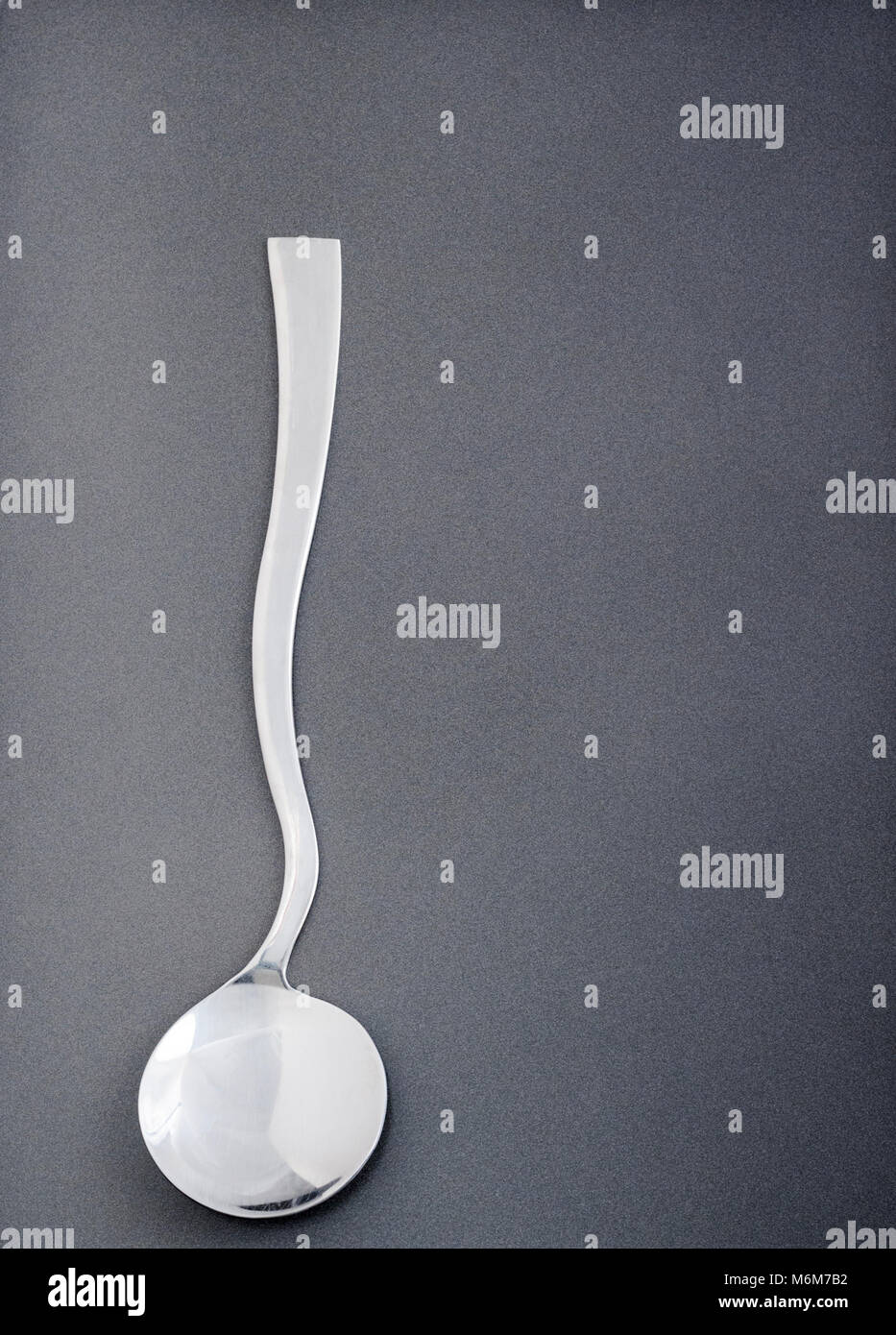 Single ultramodern metal serving spoon Stock Photo Alamy