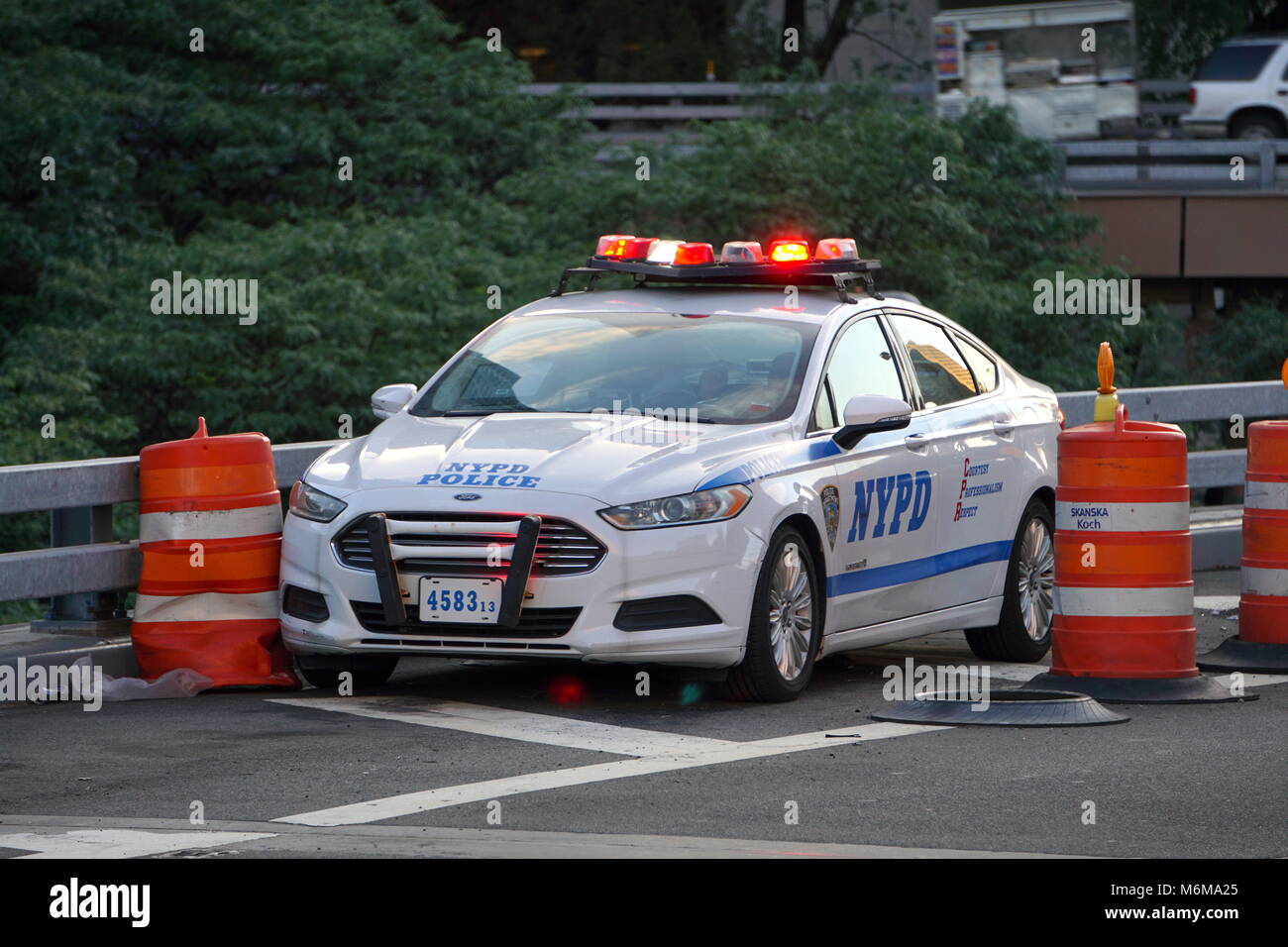 New York City, NY - June 7, 2016: NYPD police officer car sits on a Brooklyn road patrolling traffic laws and ensure driver safety. Siren lights flash Stock Photo