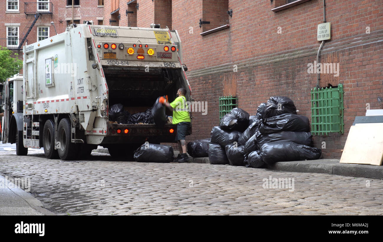 Brooklyn, NY June 7 2016 DSNY workers collect trash on a city street