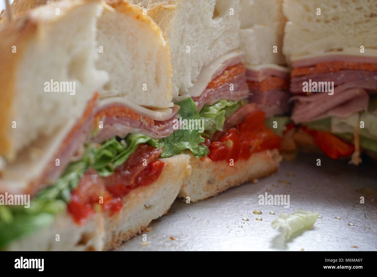 Party italian hero sliced on a tray to serve to guests. Filled with
