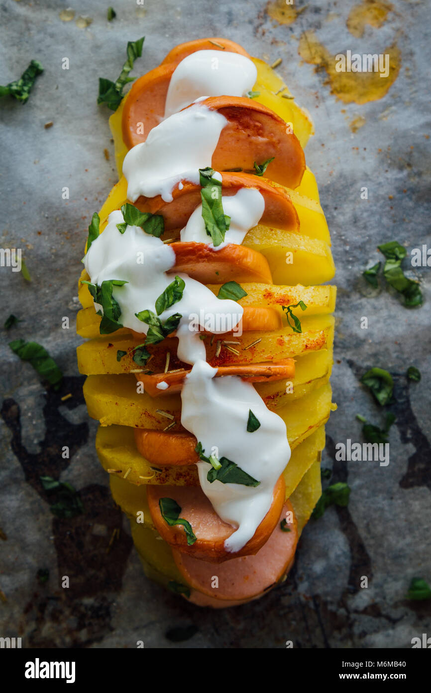 Baked hasselback potatoes with sausage and cream Stock Photo Alamy
