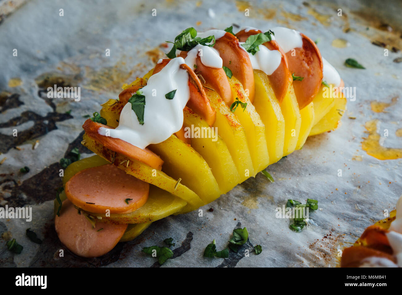 Baked hasselback potatoes with sausage and cream Stock Photo Alamy