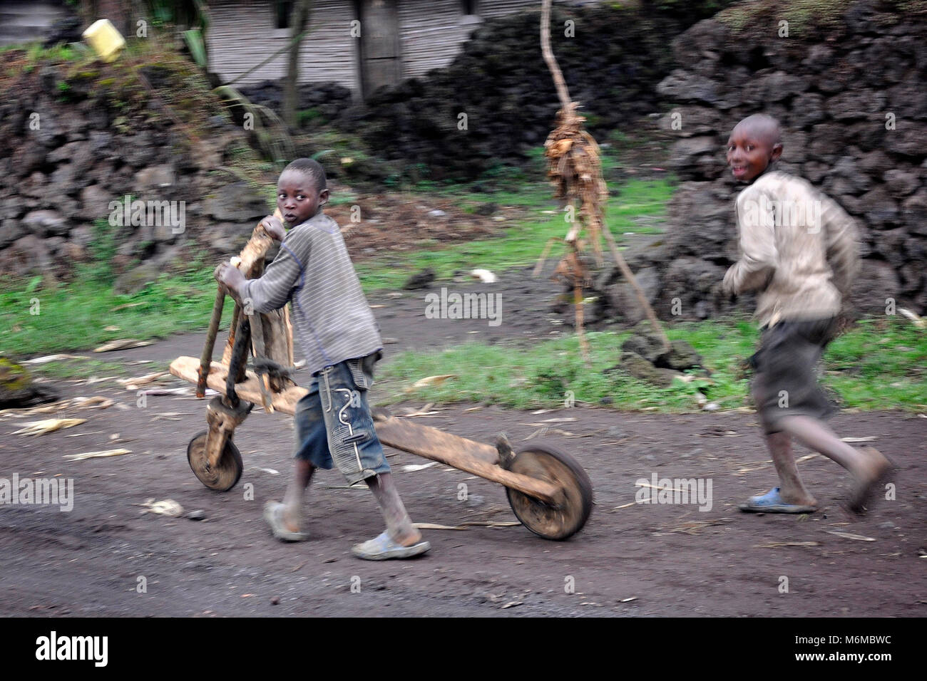 Democratic Republic of Congo, North Kivu region, Children playing with chukudu Stock Photo