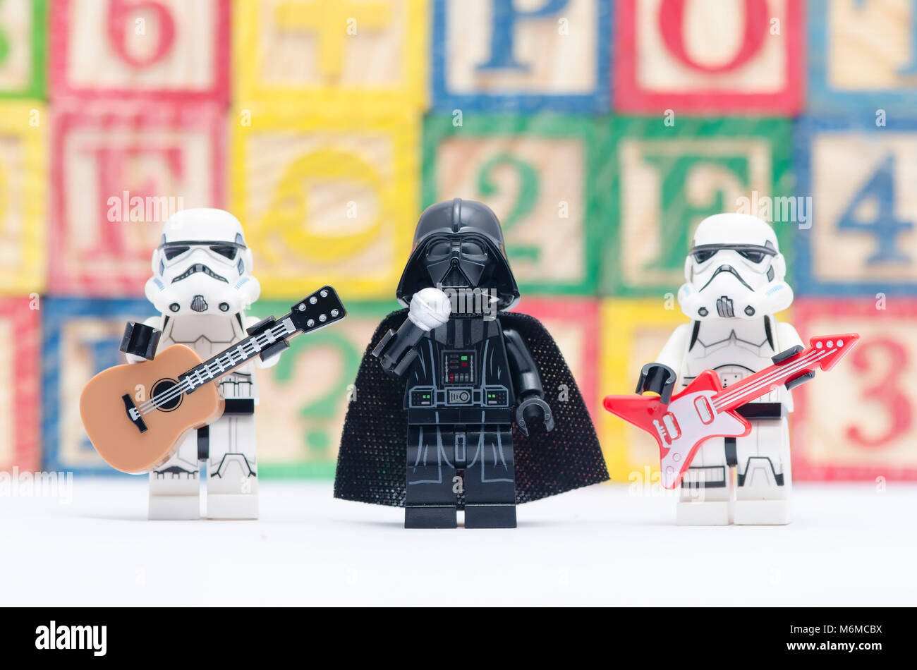 lego darth vader holding microphone with storm troopers holding guitar  isolated on white background Stock Photo - Alamy