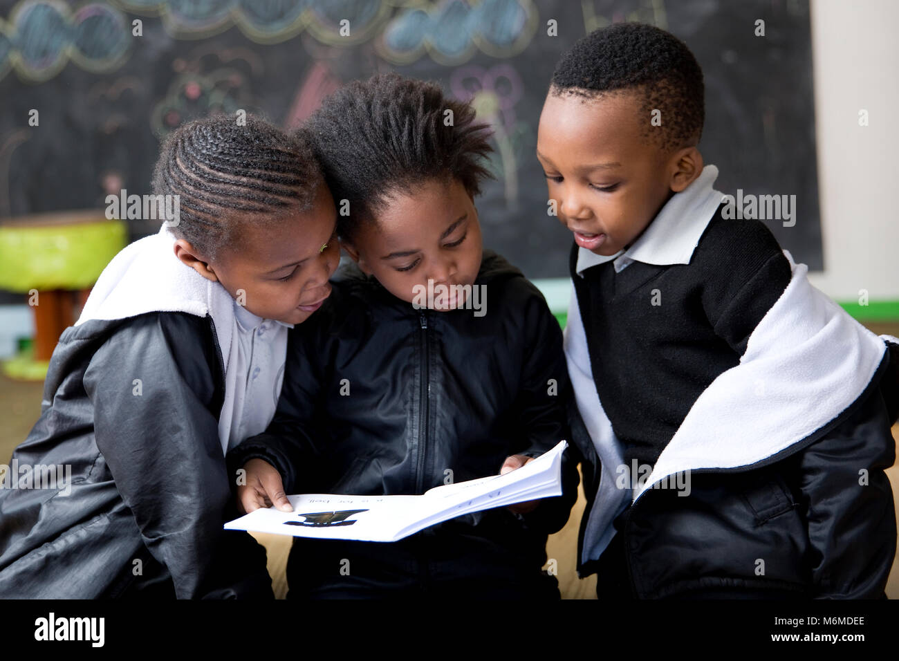 School kids reading in the classroom Stock Photo