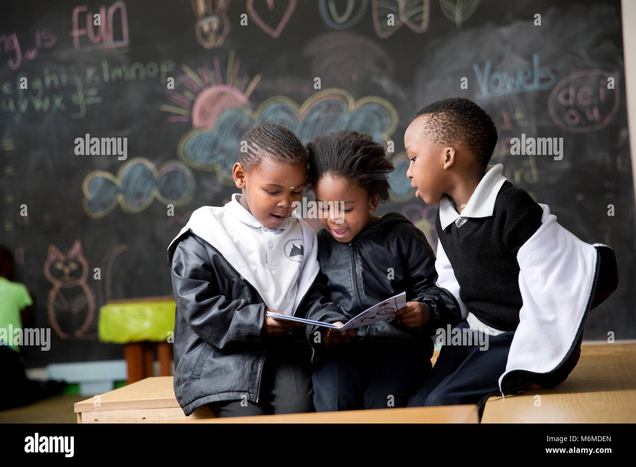 School kids reading in the classroom Stock Photo