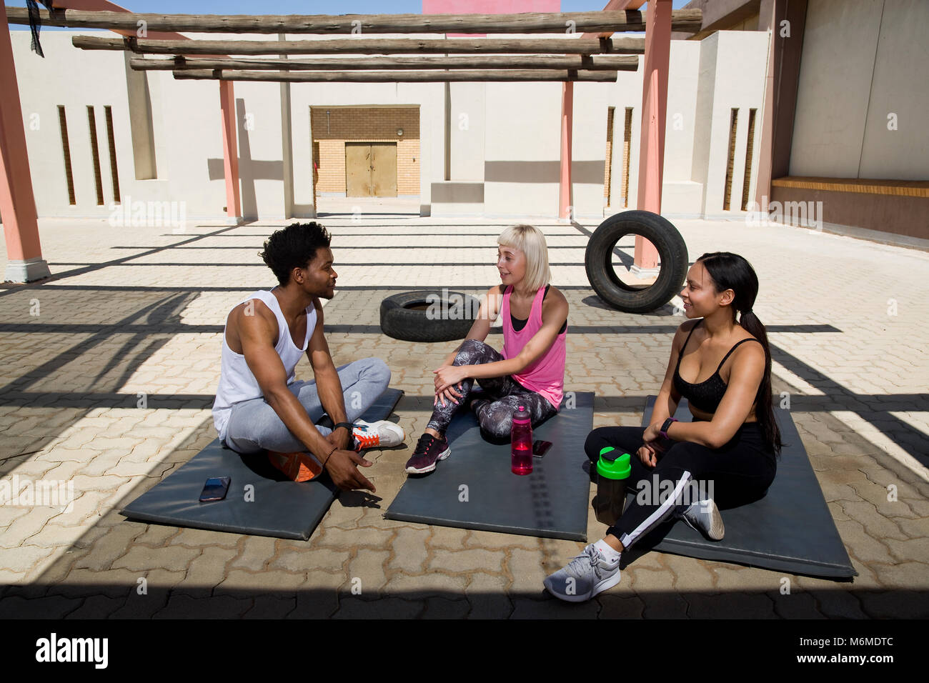 People sitting on floor in gymnasium Stock Photo - Alamy