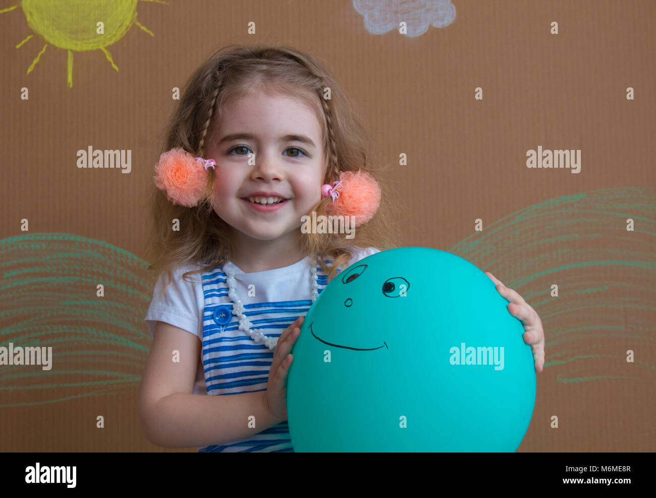 Portrait of happy girl holding a balloon with smile Stock Photo