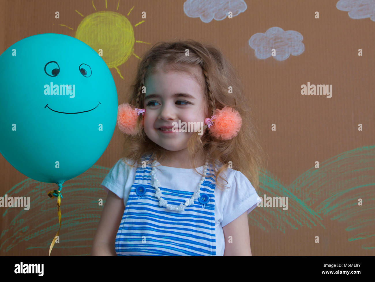 Portrait of happy girl holding a balloon with smile Stock Photo