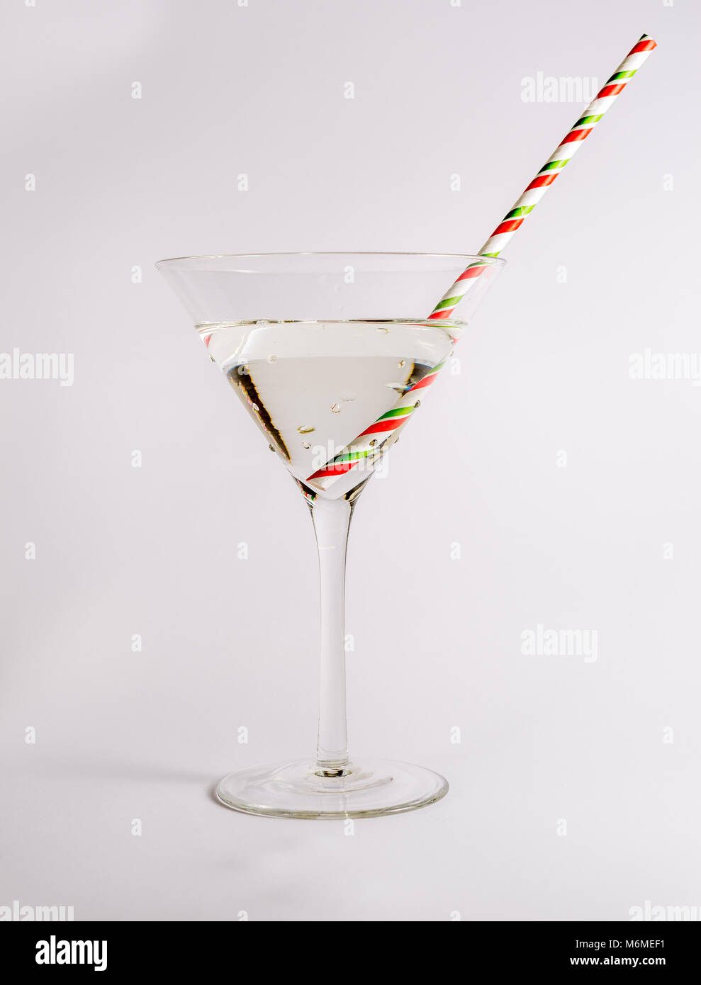 Cocktail in a cocktail glass with a straw Stock Photo