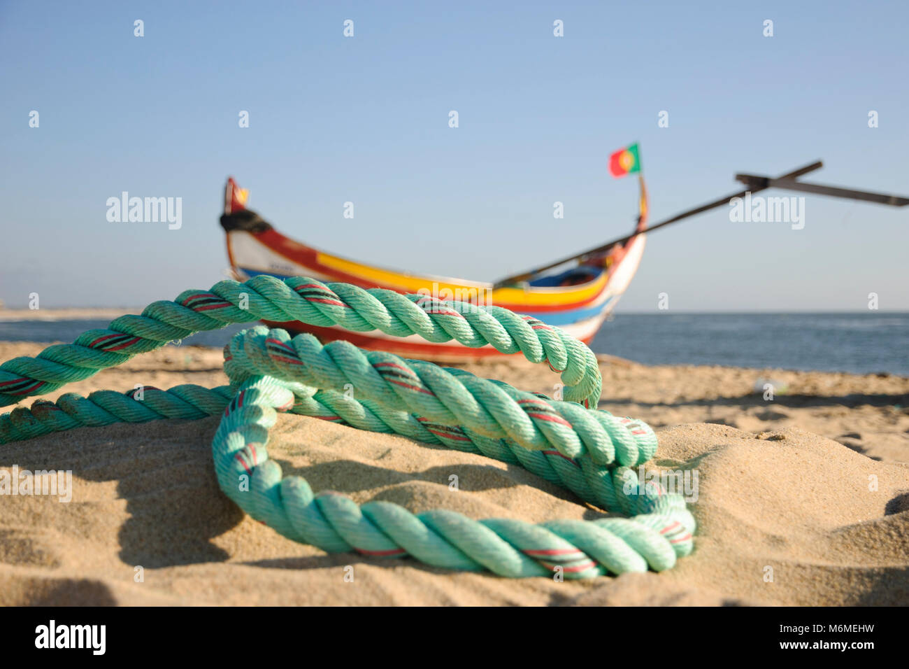 Typical old portuguese fishing boats with rope infront on the beach of Espinho, Portugal Stock