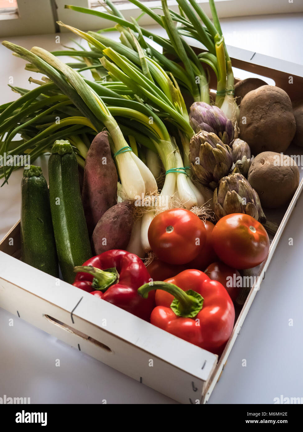 Box of a variety of organic vegetables potatoes, green onions