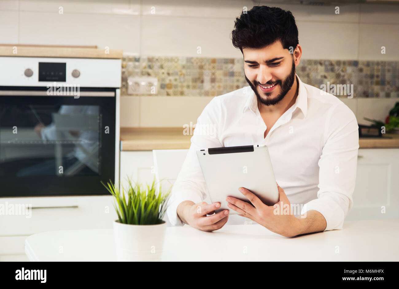 Boy with Tablet in Kitchen Stock Photo Alamy