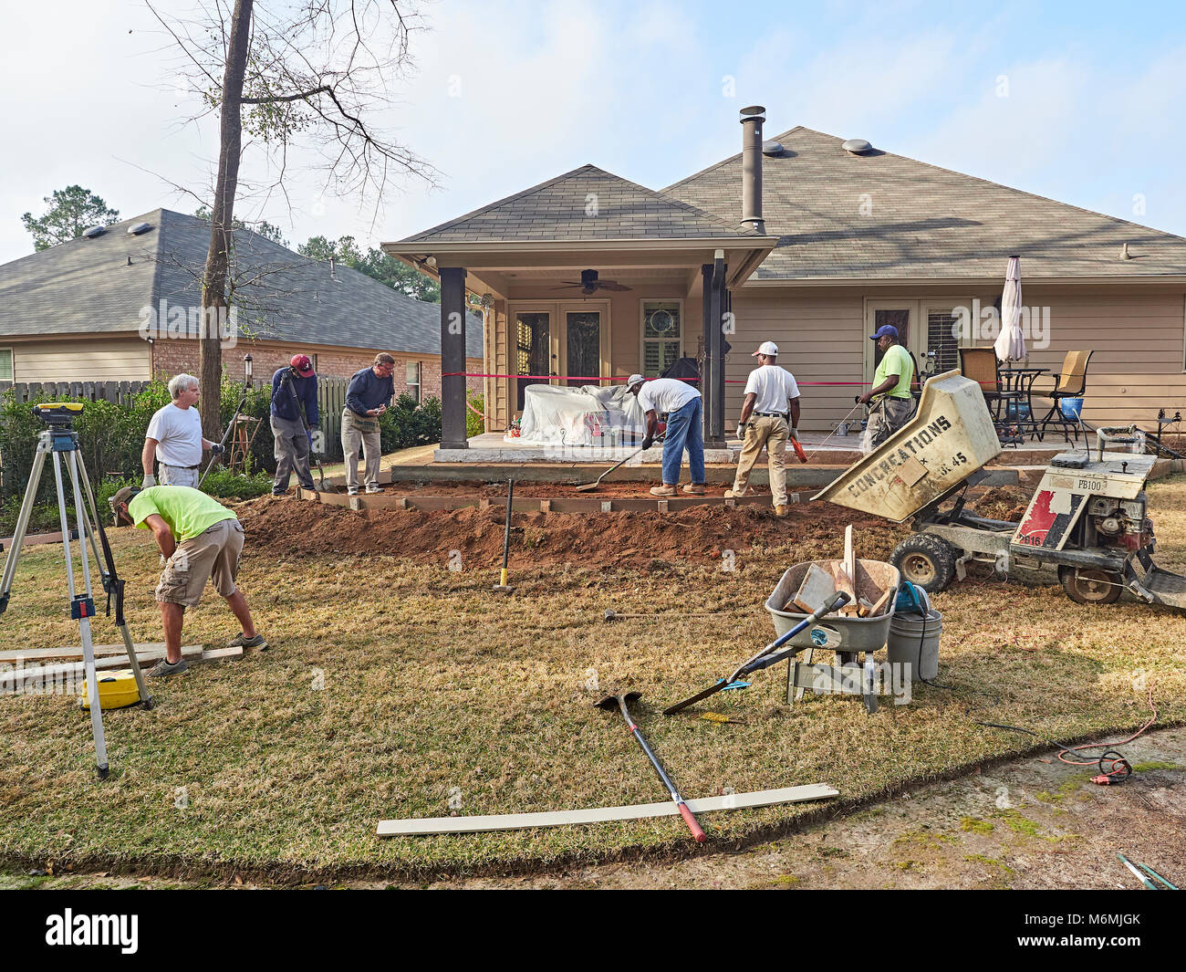 Construction workers at a residential site working on a patio for the home or house in Pike Road Alabama, USA. Stock Photo