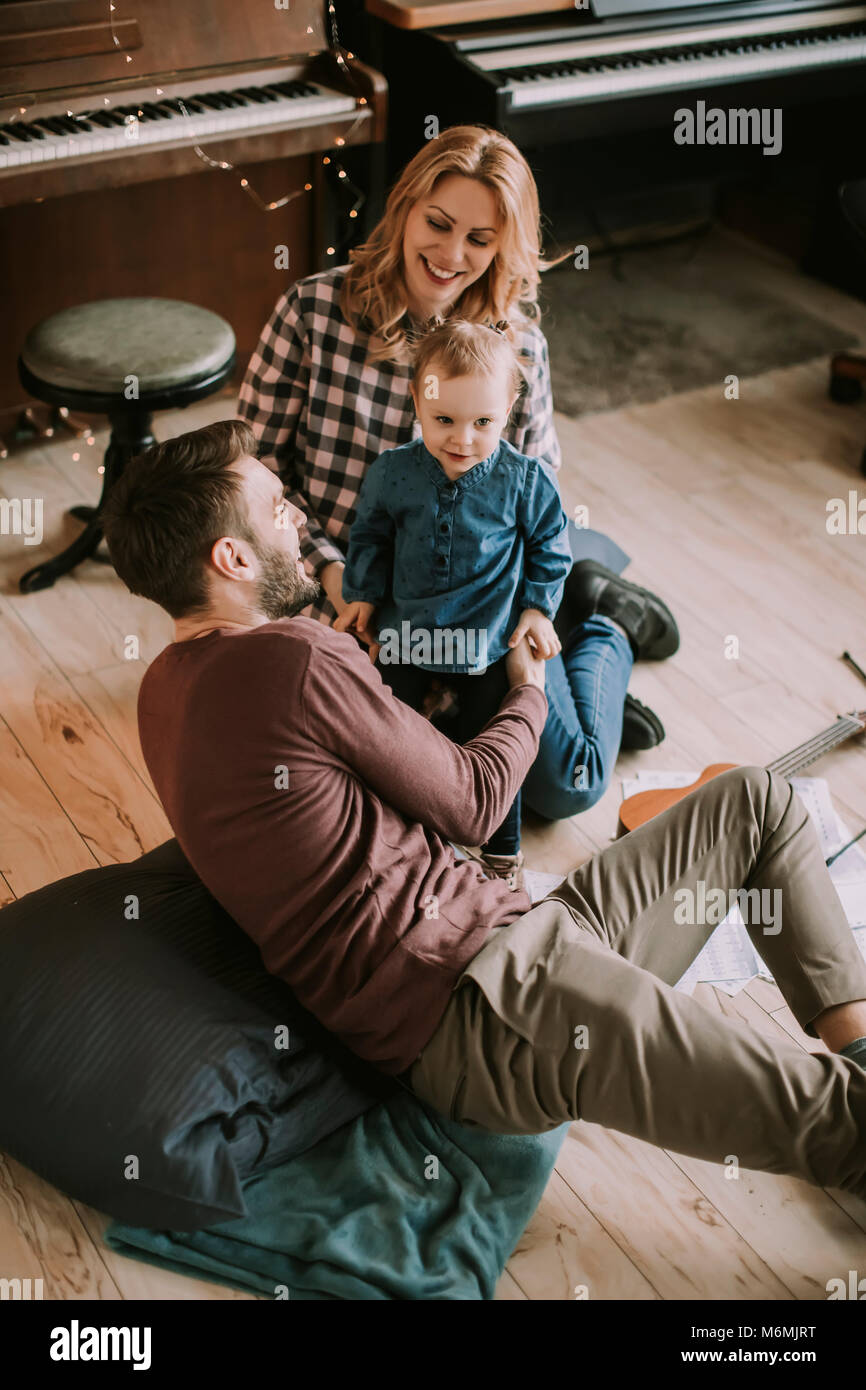 Happy young family playing on the floor in the room Stock Photo - Alamy