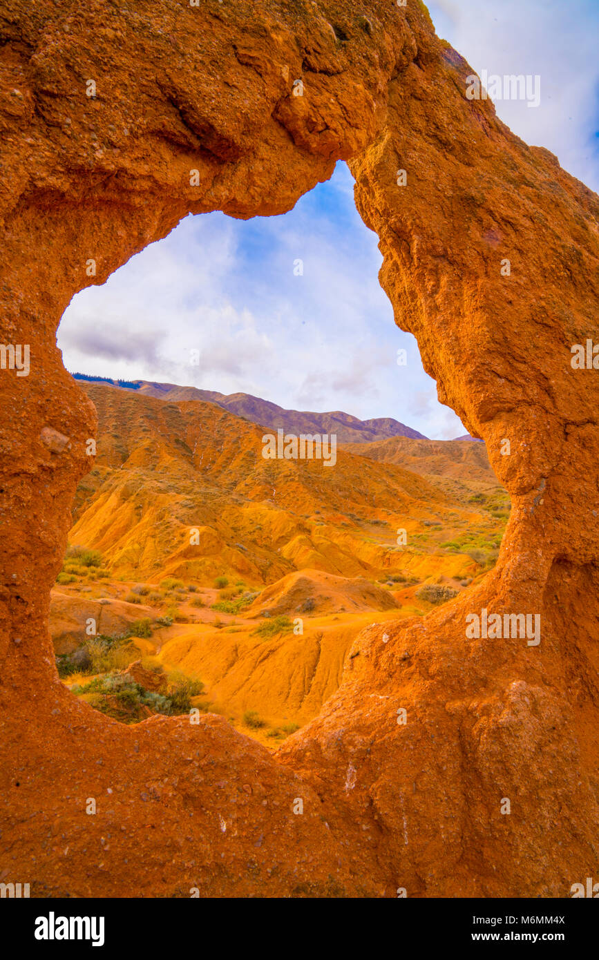 Natural arch at  Fairy Tale Canyon, Tien Shan Mountains, Kyrygyzstan, Central Asia.     Lake Issyh-Kul Stock Photo