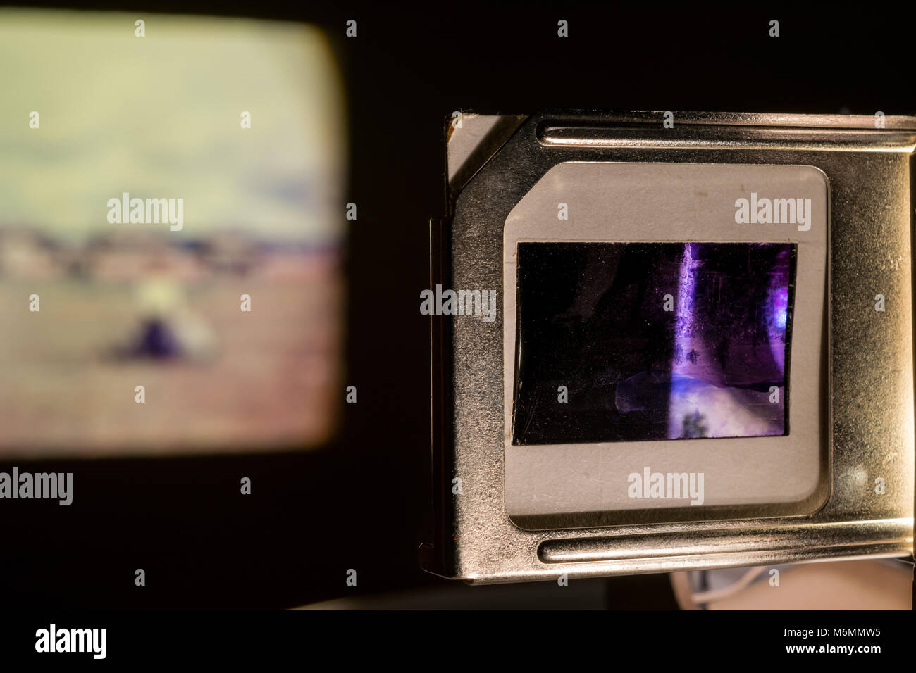 Vintage Photo Slides Projector Showing Old Photographs Slides in Dark