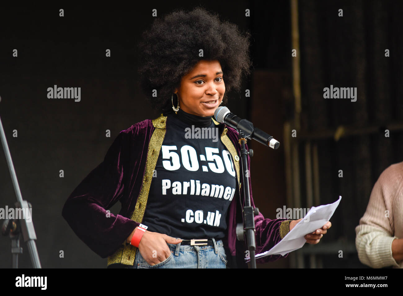Isabel Adomakoh Young of 50:50 Parliament campaign speaking at the March 4 Women equality protest organised by Care International in London Stock Photo