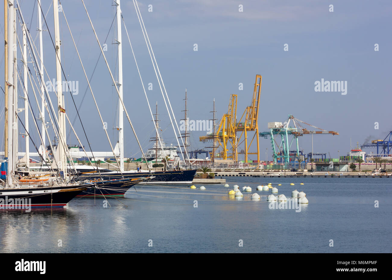 A few docked sailing ships with the seaport in the background in ...