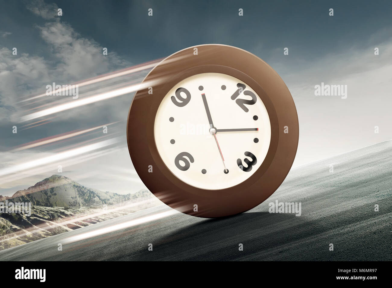 Analog clock rolling uphill to the top of mount Stock Photo Alamy