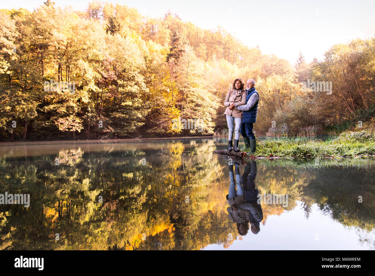 Senior couple on a walk in autumn nature Stock Photo - Alamy