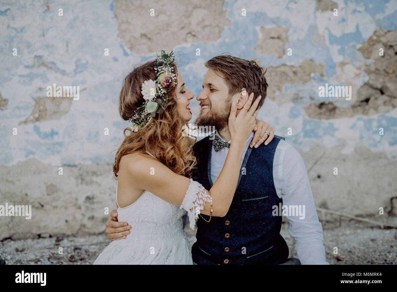 Beautiful bride and groom in front of old shabby house Stock Photo - Alamy