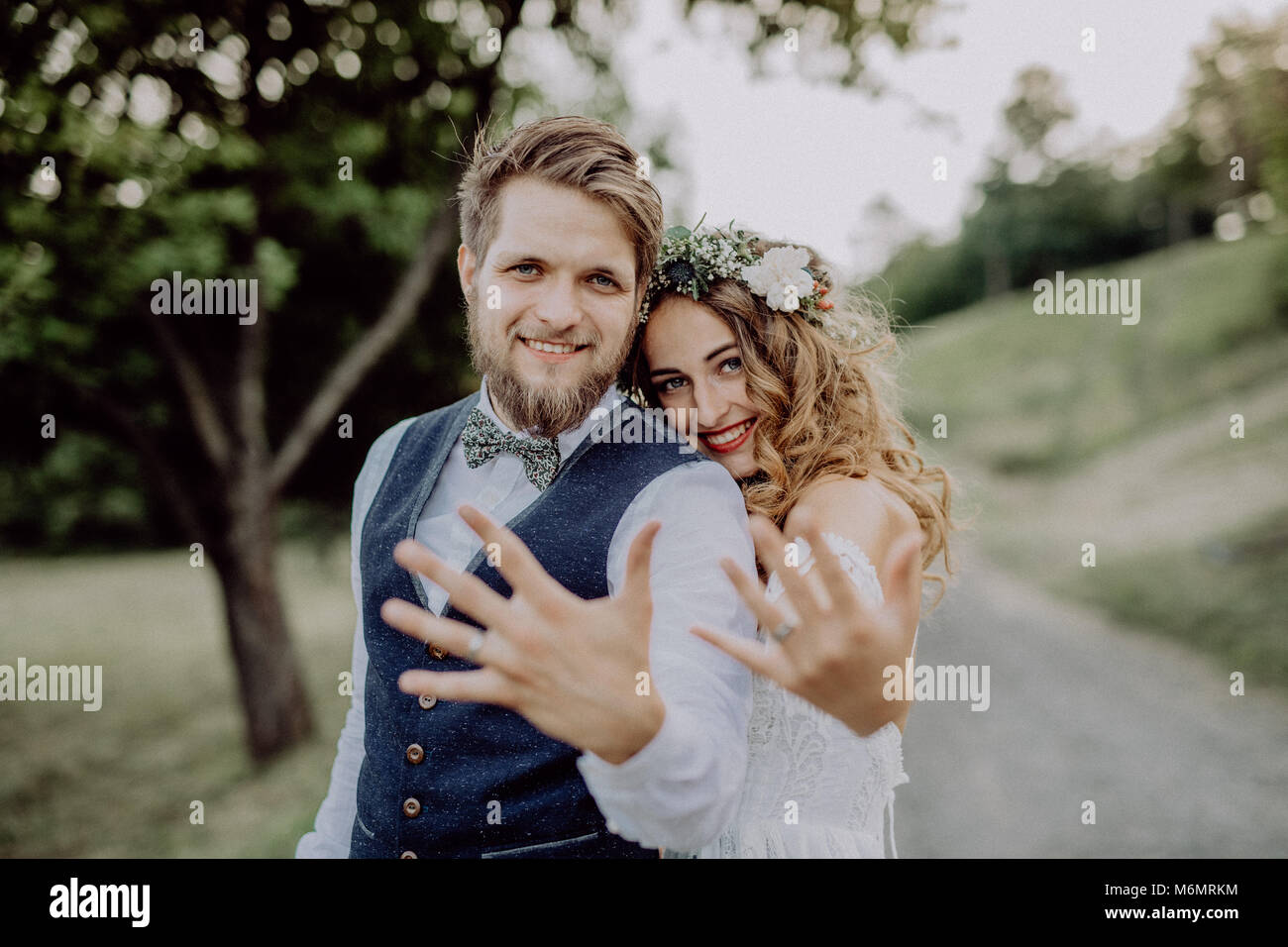 Beautiful bride and groom in green nature Stock Photo - Alamy
