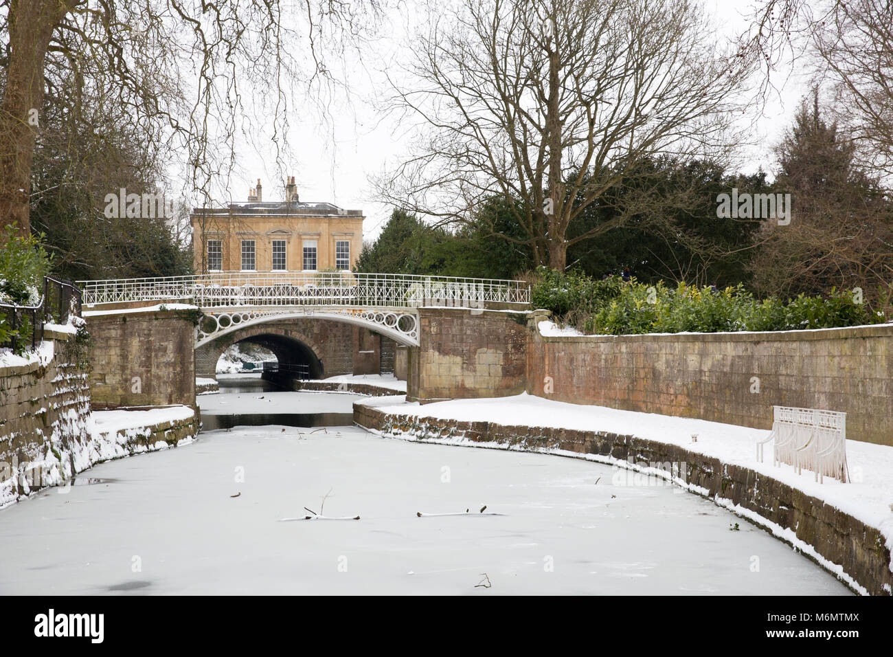 Wintry view of the Kennet and Avon Canal in Sydney Gardens, Bath, England during the big freeze at the beginning of March 2018. Stock Photo