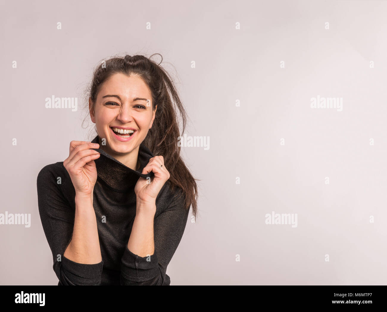Portrait of a young beautiful woman in studio. Stock Photo