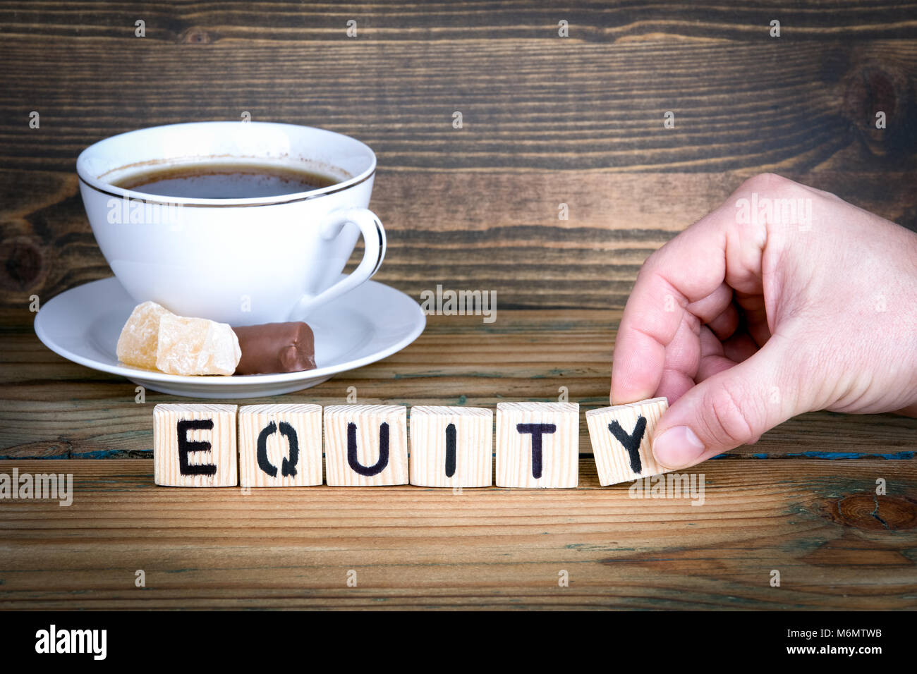 equity. Wooden letters on the office desk, informative and ...