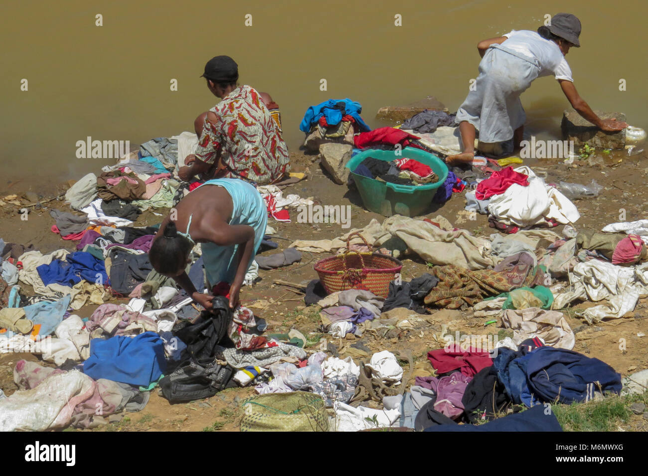 Madagascar, Analamanga region, River landscape near Antananarivo, Women washing clothes in the river Stock Photo