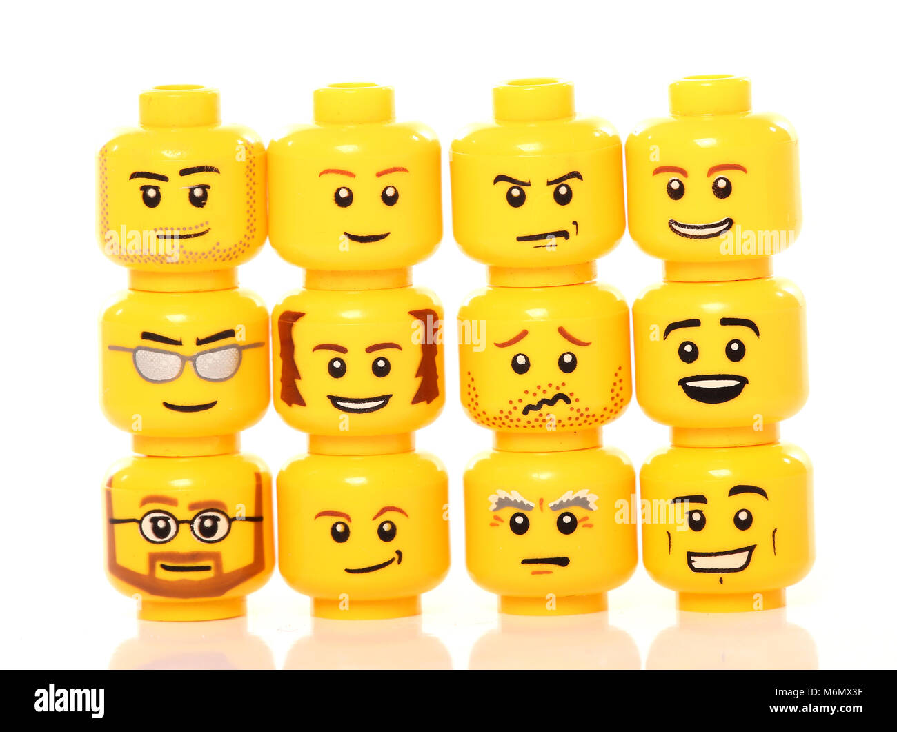 stack of lego heads on white background Stock Photo