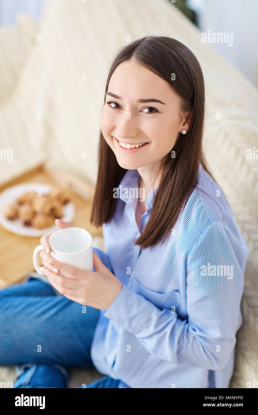 Young girl with a cup of hot drink in the kitchen Stock Photo Alamy