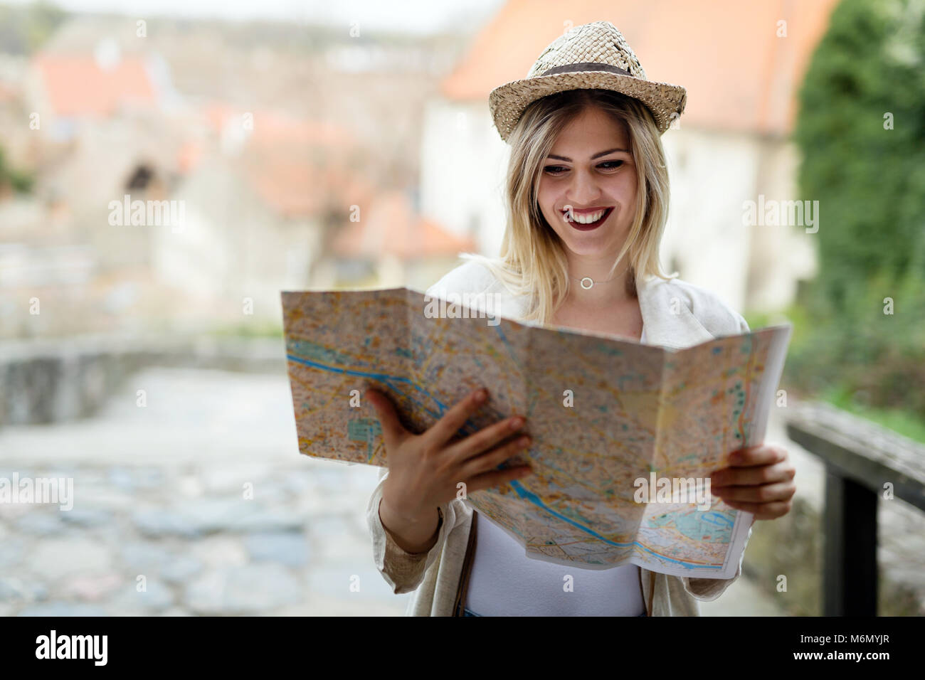 Happy blond female traveling and sightseeing Stock Photo