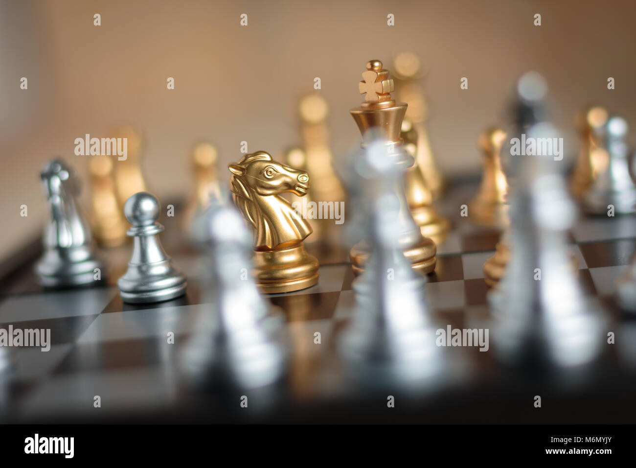 Premium Photo  The golden horse, knight chess piece standing in front of  silver pawn chess pieces on chessboard on dark background. leadership,  follower, team, commander, competition, and business strategy concept.