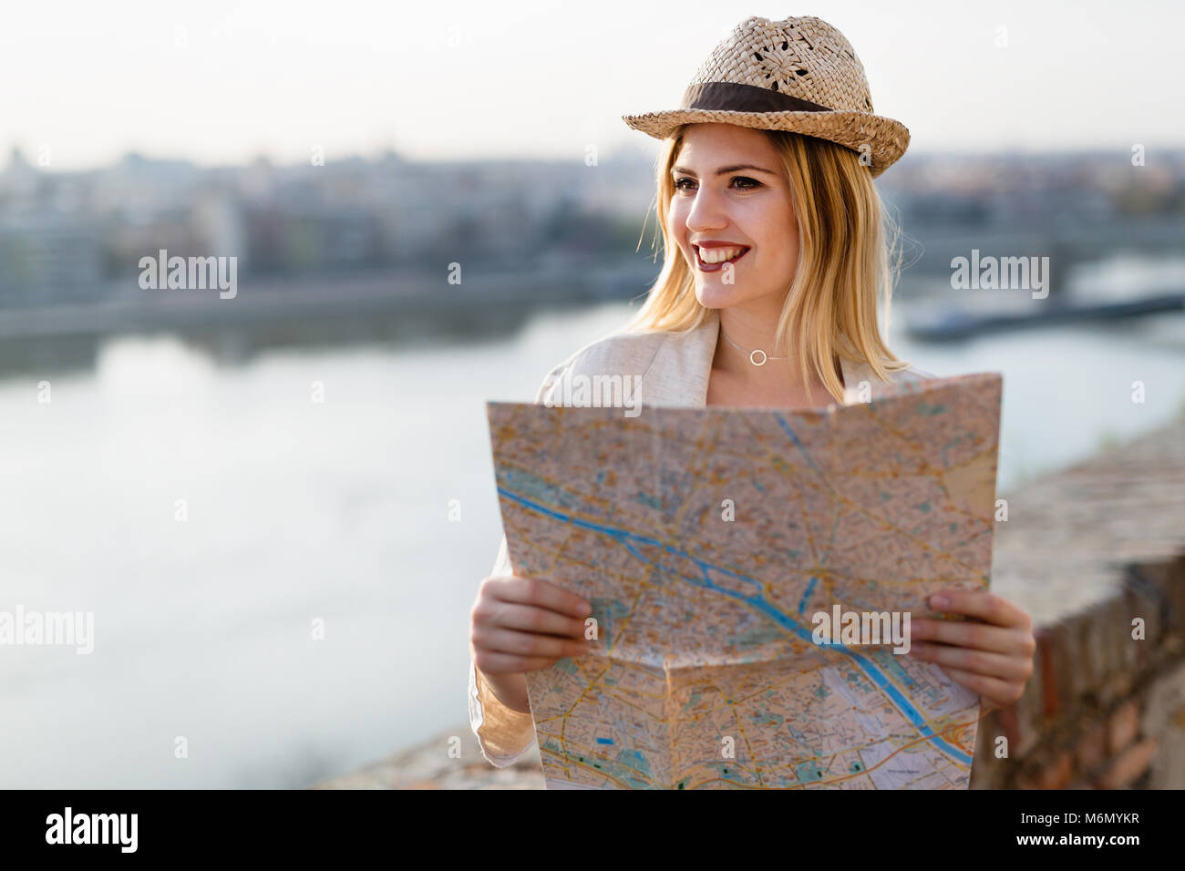 Happy blond female traveling and sightseeing Stock Photo
