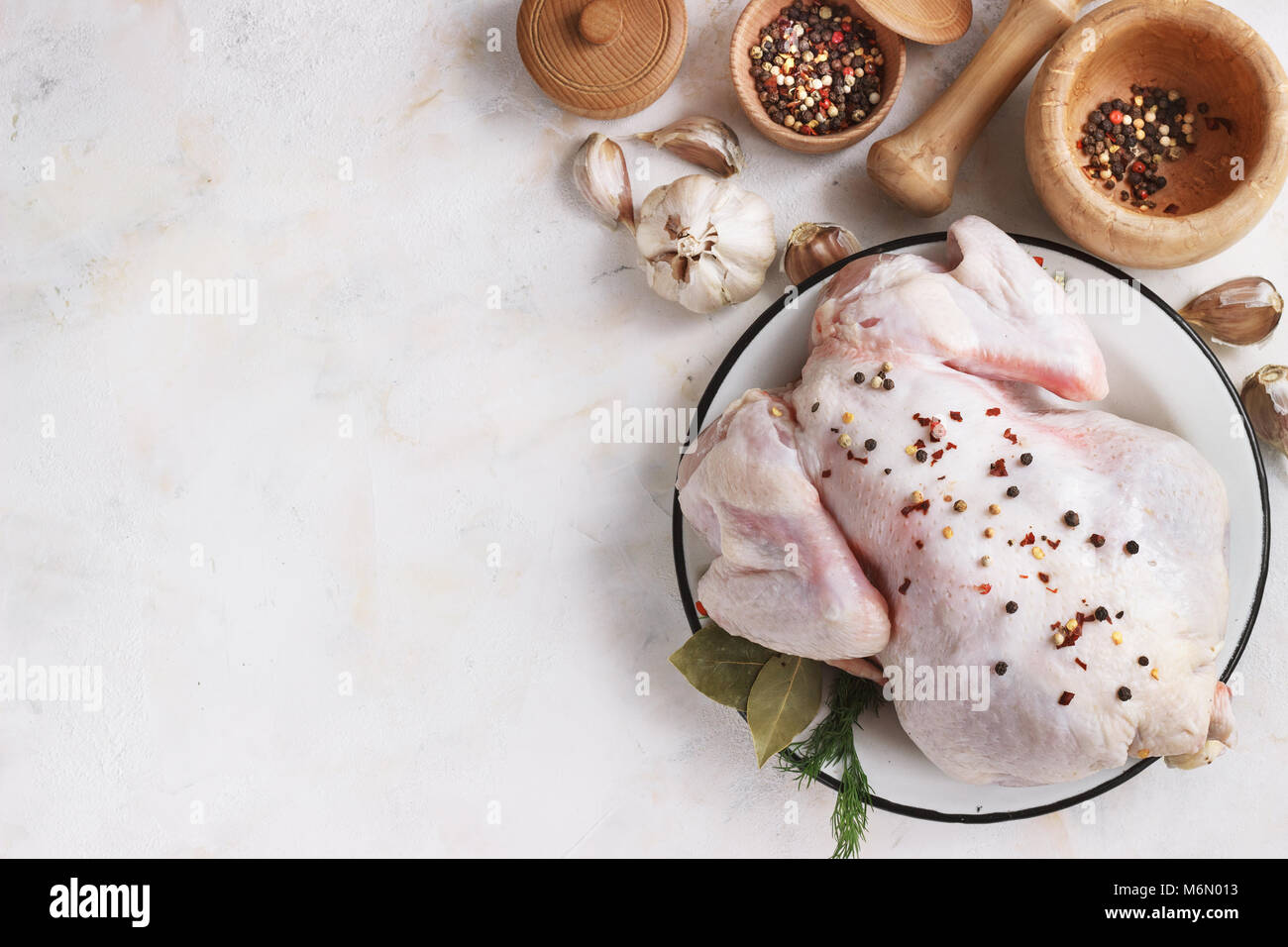 chicken with seasonings on a light background Stock Photo Alamy