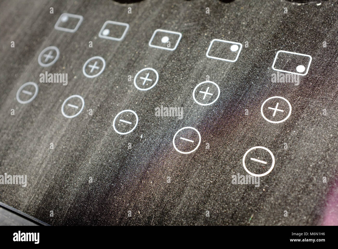 Push button controls on a dusty induction cooking hob Stock Photo