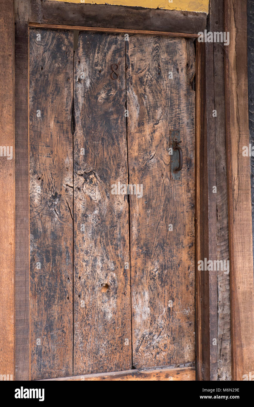 Old brown wooden door with a latch door handle Ludlow Shropshire West Midlands England Stock Photo
