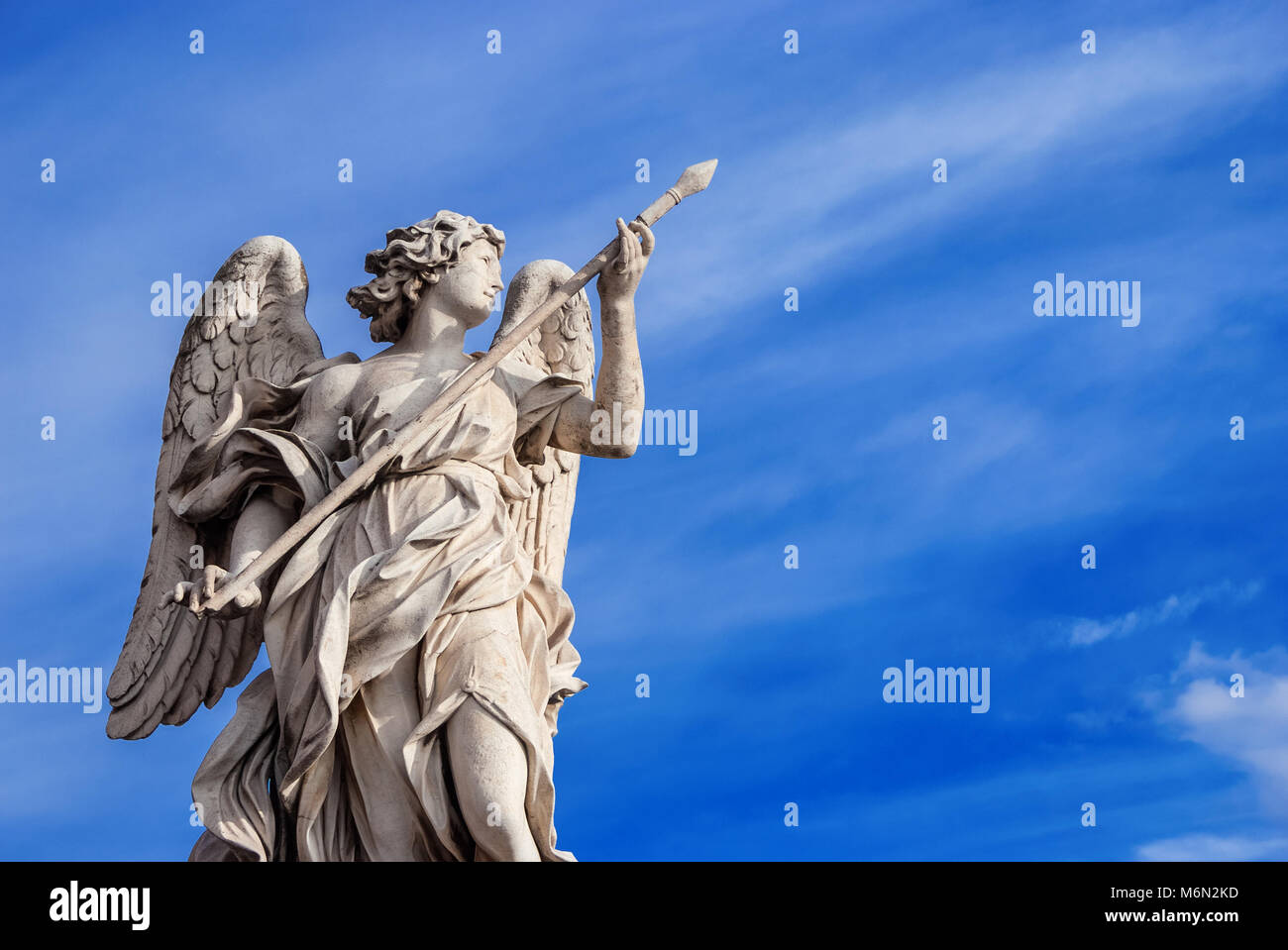 Angel holding the Holy Lance of Longinus (with beautiful sky and copy space). A 17th century baroque masterpiece at the top of Sant'Angelo Bridge in t Stock Photo