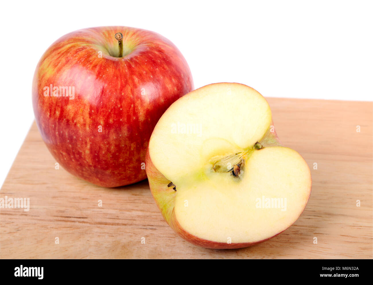 One and a half apple on wood cutting board Stock Photo