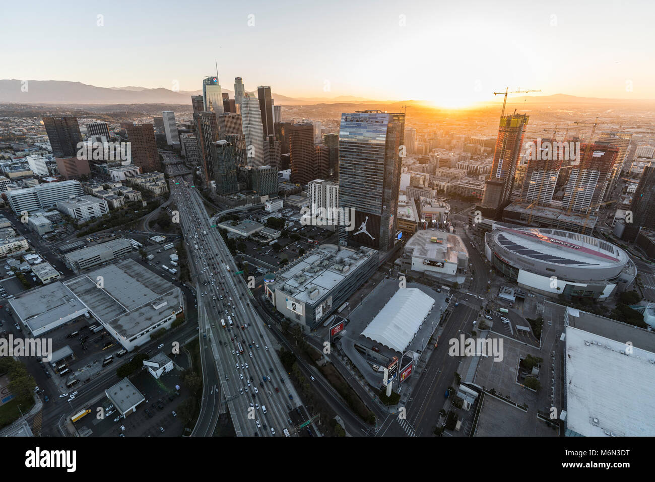 Los Angeles, California, USA - February 20, 2018:  Cityscape sunrise aerial view of towers, streets and freeway in the urban core of downtown LA. Stock Photo