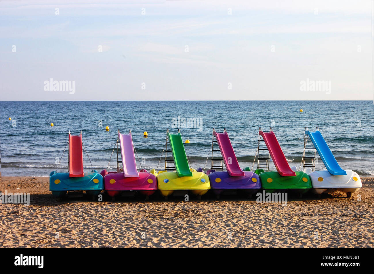 Set of six colorful pedal boat with slide on the beach of Sitges province  of Barcelona. Spain.Europe Stock Photo - Alamy