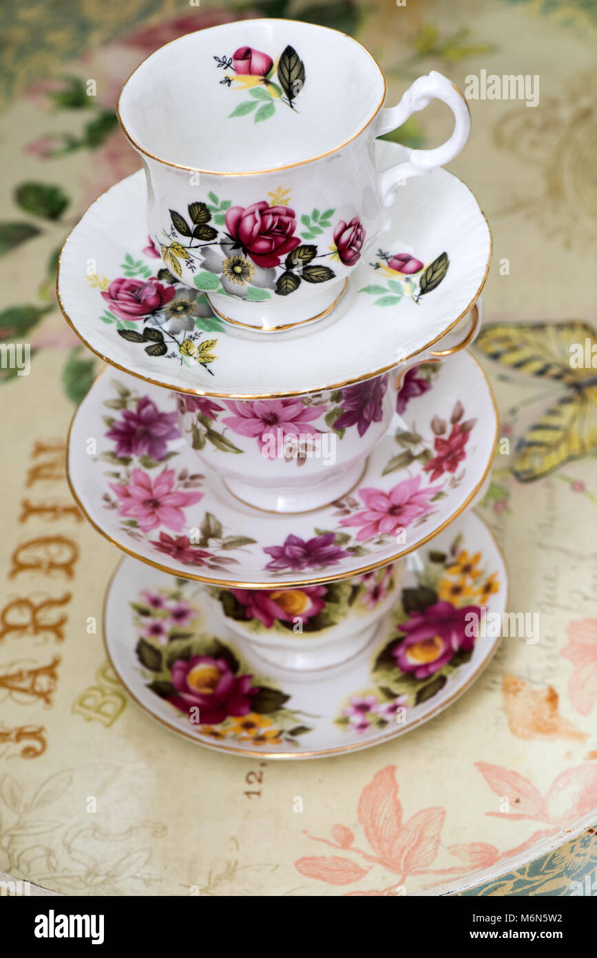 A beautiful stack of vintage porcelain tea cups and saucers with intricate floral patterns,capturing the essence of elegance and traditional craftsman Stock Photo